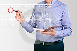 Businessman planning business schedule with notepad.