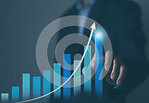 Businessman plans an effective digital stock market analysis strategy showing positive technology charts. Stock growth development