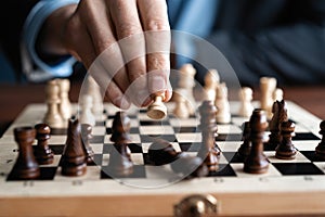 Businessman play with chess game. concept of business strategy and tactic.