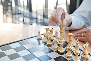 Businessman play with chess game. success management concept of business strategy and tactic challenge