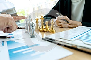 Businessman play chess on the marketing work place