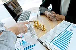 Businessman play chess on the marketing work place