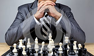 Businessman playing chess board