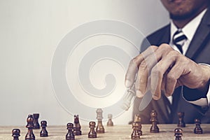 Businessman playing chess board