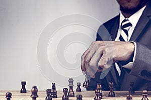 Businessman playing chess board