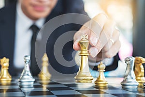 Businessman playing chess figure take a checkmate another king with team, strategy or management win or success concept