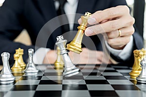 Businessman playing chess figure take a checkmate another king with team, strategy or management win or success concept