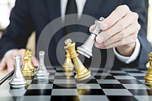 Businessman playing chess figure take a checkmate another king with team, strategy or management win or success concept