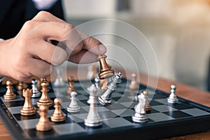 Businessman playing chess game beat opponent with strategy concept