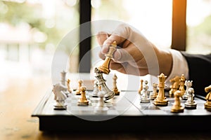 Businessman playing chess game beat opponent with strategy concept