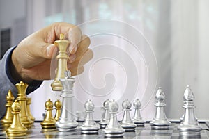 Businessman playing chess game; for business strategy, leadership and management concept