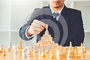 Businessman playing chess game Planning of leading strategy successful business leader concept