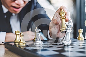 Businessman playing chess game reaching to plan strategy for success, thinking for planning overcoming difficulty and achieving