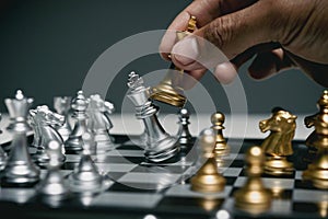 businessman playing chessboard, Competition in business, Hand of confident businessman use king chess piece playing to crash