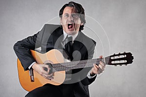 Businessman playing the guitar