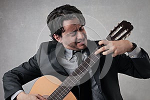 Businessman playing the guitar