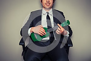 Businessman playing ukulele