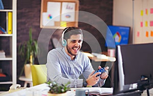 Businessman playing videogames in his office photo