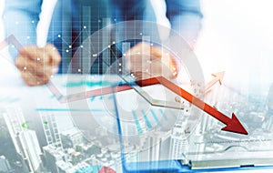 Businessman point at decreasing graph and increasing broken graph photo