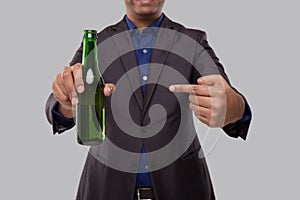 Businessman Pointing at Beer Bottle. Indian Business man With Beer bottle in Hand Close Up