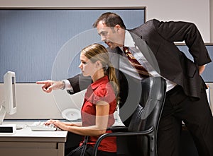 Businessman pointing at co-workers computer