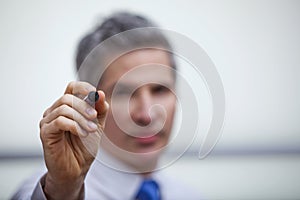 Businessman pointing with a felt tip pen