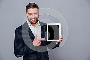 Businessman pointing finger on tablet computer screen