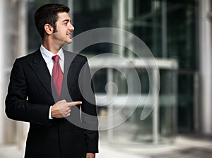 Businessman pointing his finger to the copyspace