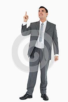 Businessman pointing and looking upwards