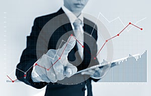 Businessman pointing raising graph on screen. Business growth, investment and finance concept
