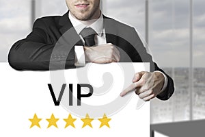 Businessman pointing on sign vip golden stars