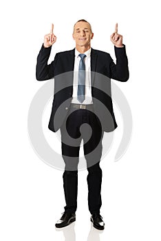 Businessman pointing upwards