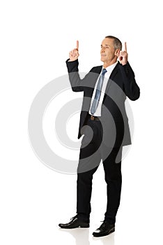 Businessman pointing upwards