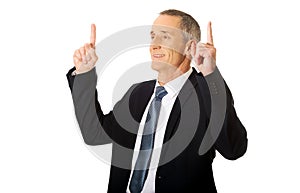 Businessman pointing upwards