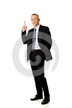 Businessman pointing upwards