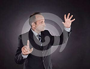 Businessman pointing at a virtual point. photo on black background