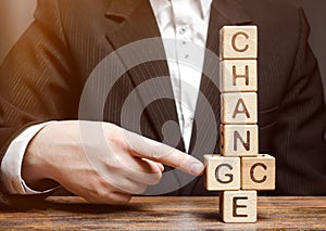 Businessman points to wooden blocks with the word Change to Chance. Personal development. Career growth or change yourself concept