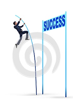 The businessman pole vaulting over towards his success career