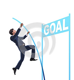 Businessman pole vaulting towards his goal in business concept