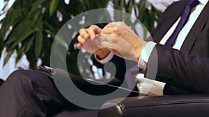 Businessman or politician giving live interview. Body language gesticulation with hands. Close up shot.