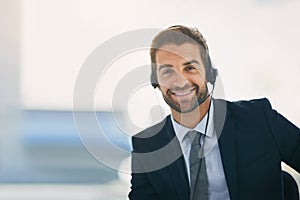 Businessman, portrait and advisor with headphones at call center for customer service or support at office. Happy man