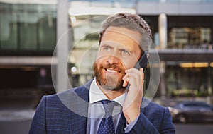 Businessman portrait. Man on smart phone. Casual urban professional business man using smartphone smiling happy