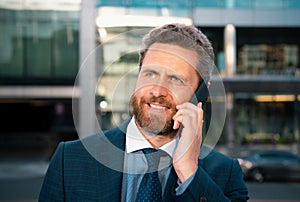 Businessman portrait. Man on smart phone. Casual urban professional business man using smartphone smiling happy