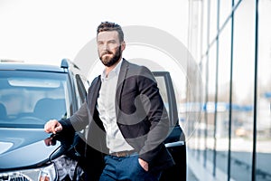 Businessman portrait near the car