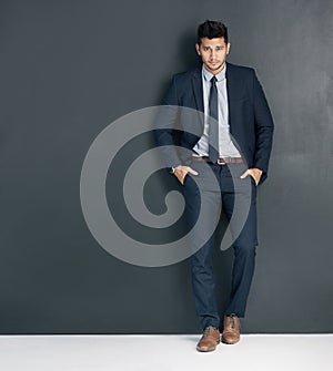 Businessman, portrait and style with fashion in confidence for career ambition on a dark wall background. Full body of