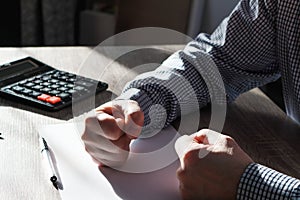 Businessman pounding fist on table, cropped image. Angry businessman showing his fists. Frustrated businessman hand clenched fists