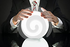 Businessman Predicting Future With Crystal Ball photo