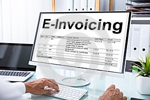 Businessman Preparing E-invoicing Bill On Computer