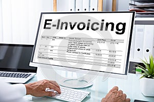 Businessman Preparing E-invoicing Bill On Computer photo