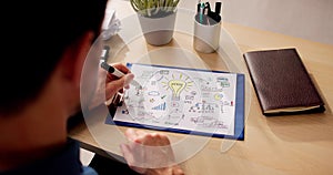 Businessman Preparing Startup Plan On Paper At Table photo